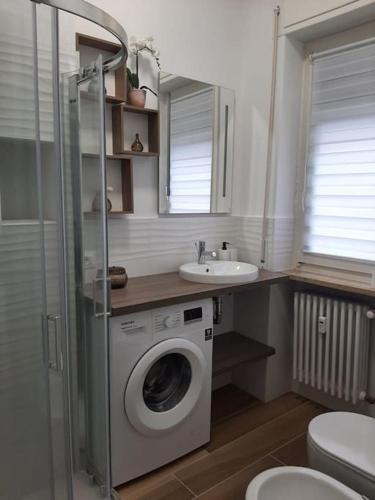 a bathroom with a washing machine and a sink at Arona Lovely House in Arona