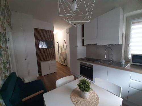 a kitchen and living room with a table and chairs at Arona Lovely House in Arona