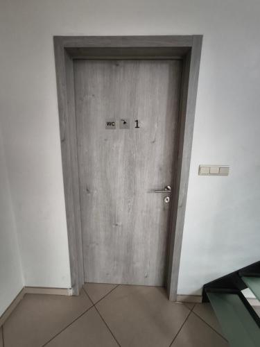 a wooden door with the words we written on it at 8 chambres privées dans une villa de luxe partagée de 350m2 in Charleroi