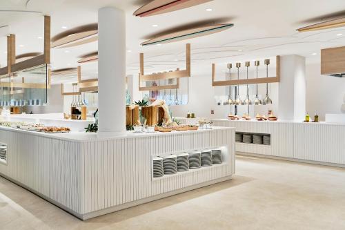 a restaurant with a white counter with food at Iberostar Waves Gaviotas Park in Morro del Jable