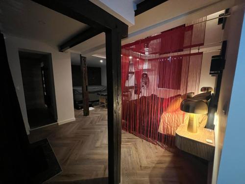 a room with a glass door with a bed and a lamp at Le fruit défendu 67 in Brumath