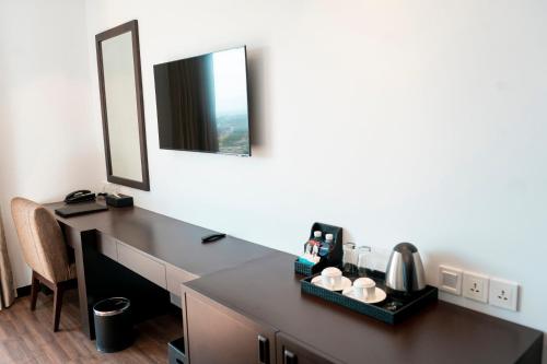 a bathroom with a vanity with a mirror at TUI BLUE Tuy Hoa - Wellness & Retreat Hotel in Tuy Hoa
