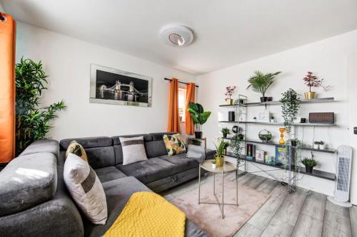 a living room with a couch and a table at GuestReady - Urban Comfort near Wembley Stadium in London