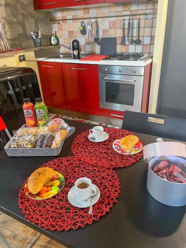 a kitchen with a table with food and cups of coffee at La casa di Anastasiia in Vitorchiano