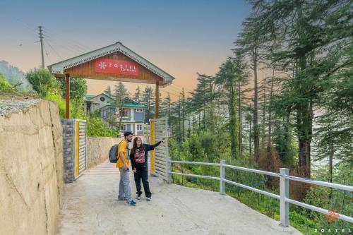 two people standing on a bridge in the mountains at Zostel Kotgarh, Narkanda in Kotgarh