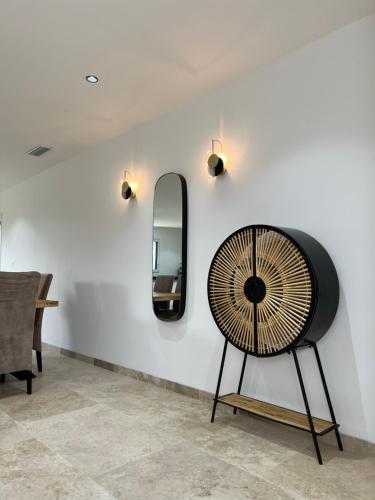 a room with a chair and a mirror on a wall at Villa Sous l'Olivier de Provence in Morières-lès-Avignon