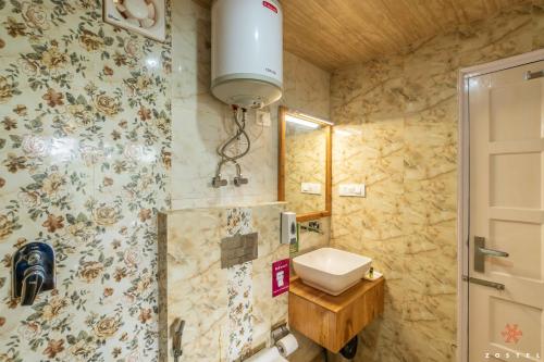 a bathroom with a shower with a sink and a toilet at Zostel Kotgarh, Narkanda in Kotgarh