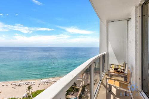 a balcony with a view of the beach and ocean at Ocean View Luxurious Studio Premium Amenities in Sunny Isles Beach