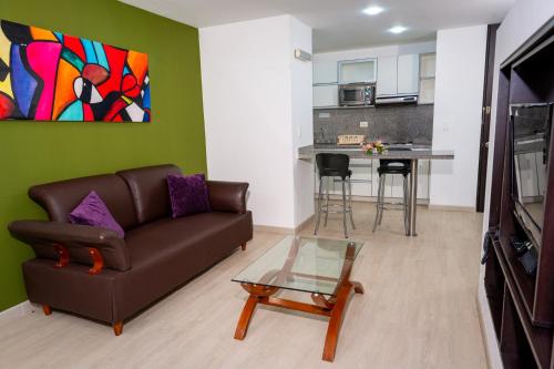 a living room with a couch and a table at 122 Plaza Apartahotel in Bogotá