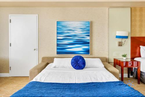 a bedroom with a bed with a blue pillow on it at Ocean View Luxurious Studio Premium Amenities in Sunny Isles Beach
