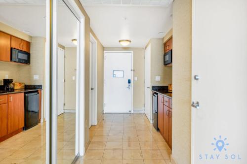 a hallway with a door leading to a kitchen at Ocean View Luxurious Studio Premium Amenities in Sunny Isles Beach