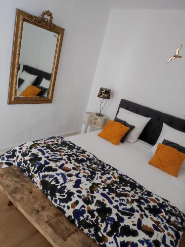 une chambre avec un grand lit avec un miroir dans l'établissement maison d'hôtes chez Sylvie et Guy QUENARD, à Chignin