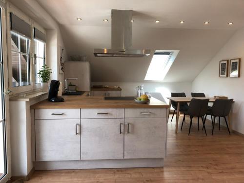 a kitchen and dining room with a table with chairs at Wohnung Am Spitalgarten für 4 Personen in Gundelfingen an der Donau