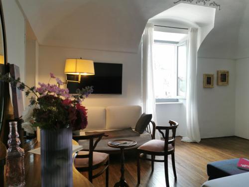 a living room with a couch and a table at Archè in Ivrea