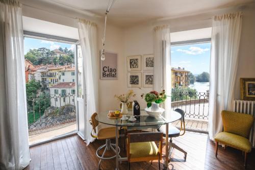 a dining room with a table and a large window at Archè in Ivrea