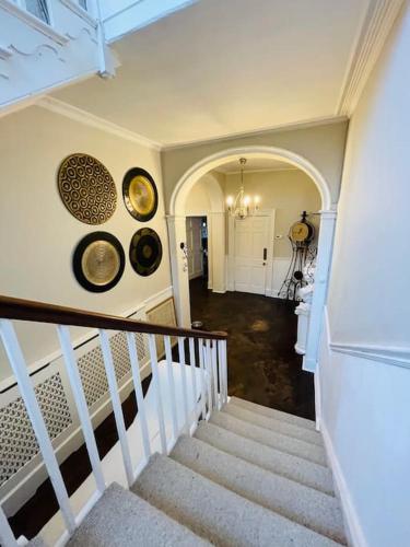a staircase in a house with two plates on the wall at Uplands House Tewkesbury in Tewkesbury