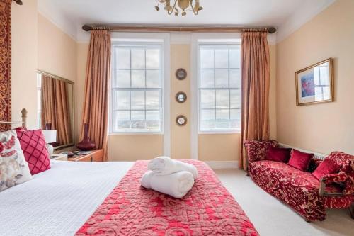 a bedroom with a bed with a stuffed animal on it at Uplands House Tewkesbury in Tewkesbury
