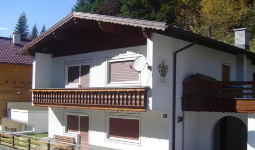 a white house with a balcony on the side of it at Ferienchalet HOLDERNACH in Kappl