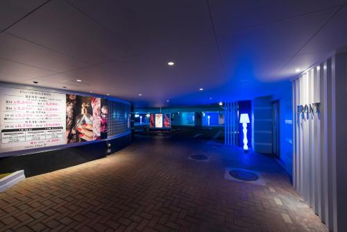a room with a movie poster on the wall at ホテルディオールセブン郡山 in Koriyama