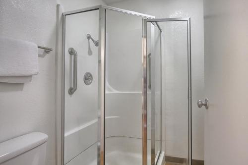 a shower with a glass door in a bathroom at Motel 6-New Cumberland, PA - Harrisburg - Hershey South in New Cumberland