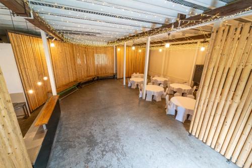 an empty room with tables and white chairs at Stodola Humno 11 in Těšetice