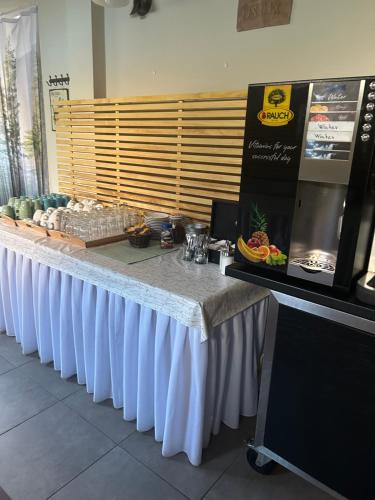 a long table with a white table cloth at Hotel & Restaurace Pizzerie Jasany in Znojmo