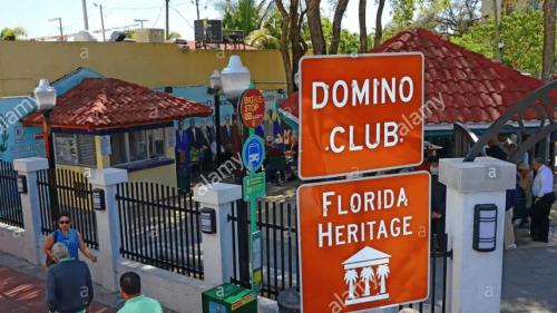a bunch of street signs in front of a fence at Coco Sol 2 by MyMiamiStay in Miami