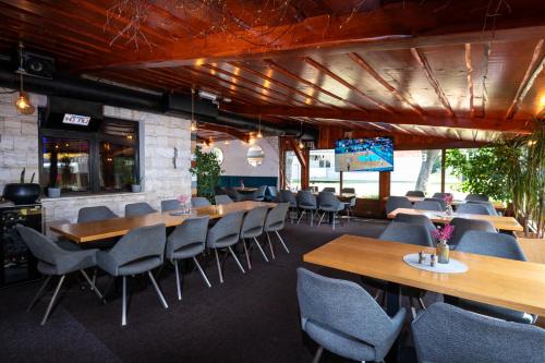a restaurant with tables and chairs in a room at Boutique hotel Vila Efekt in Ružomberok