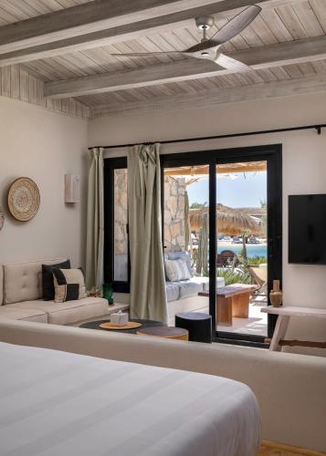 a bedroom with a bed and a living room at Marmarica Boutique Cabanas - Ras El Hekma - North Coast Top Rated Luxury Stay in Marsa Matruh