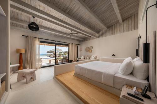 a bedroom with a bed and a view of the ocean at Marmarica Boutique Cabanas - Ras El Hekma - North Coast Top Rated Luxury Stay in Marsa Matruh