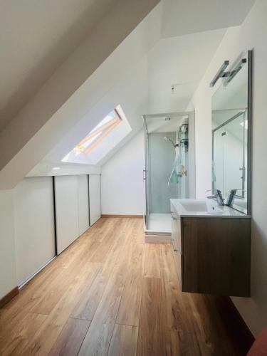 a bathroom with a sink and a shower at La Mélusine in Quettetot