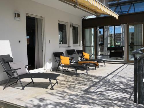 eine Gruppe von Stühlen auf einer Terrasse in der Unterkunft Wohnung Am Kreuzberg für 8 Personen in Medlingen