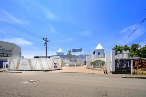 a street with white buildings and a street with a road at ホテルディオールセブン郡山 in Koriyama