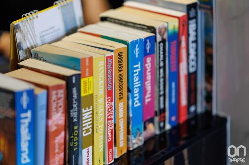 a row of books sitting on a shelf at ON Thapae Gate Chiangmai in Chiang Mai