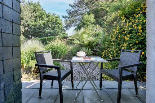 a table and two chairs on a patio at Hotel Le Branhoc - Brit Hotel Auray in Auray