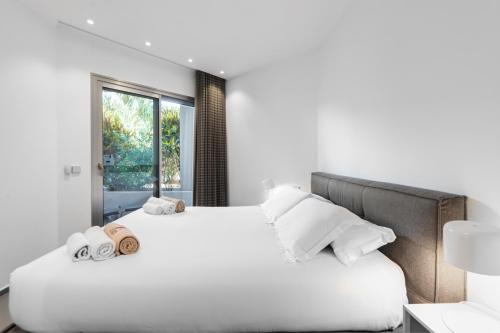 a bedroom with two beds and a window at Agora 0-3 DELUXE 1B in Palm-mar