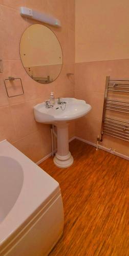 a bathroom with a white sink and a mirror at Sportsmans Valley Hotel in Liskeard