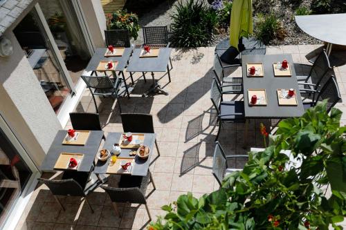 an overhead view of tables and chairs on a patio at Hotel Le Branhoc - Brit Hotel Auray in Auray