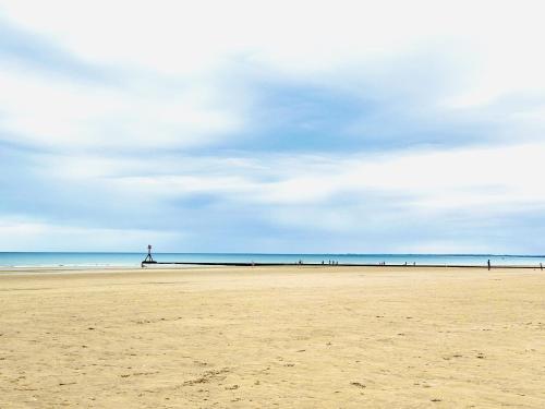 a view of a beach with people in the distance at Warren Cottage in Bridlington