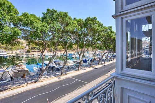 a balcony with a view of a marina at Marina View Apartment in Tal-Pietà