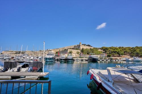 a bunch of boats docked in a marina at Marina View Apartment in Tal-Pietà