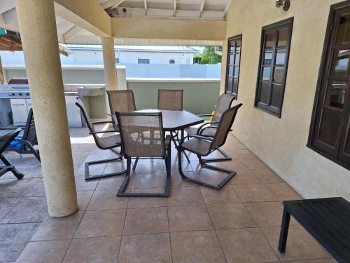 a patio with a table and chairs on a patio at Driftwood 85 in Canaan