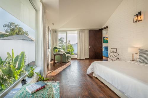 a bedroom with a large bed and a large window at La Maroma 3 BHK Splendid Villas in Anjuna - Pvt Pool- Garden & Caretaker in Vagator