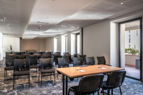 a conference room with a table and chairs in it at Hotel du Roi & Spa by SOWELL COLLECTION in Carcassonne