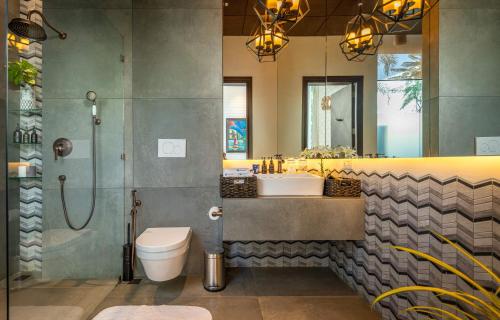 a bathroom with a sink and a toilet and a shower at La Maroma 3 BHK Splendid Villas in Anjuna - Pvt Pool- Garden & Caretaker in Vagator