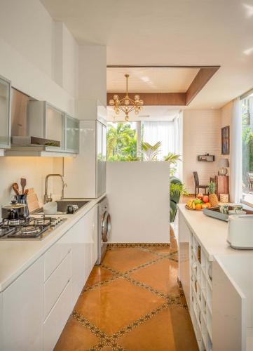 a kitchen with white cabinets and a counter top at La Maroma 3 BHK Splendid Villas in Anjuna - Pvt Pool- Garden & Caretaker in Vagator