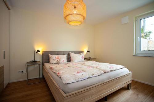 a bedroom with a large bed with two pillows at Ferienwohnung Will in Bodman-Ludwigshafen