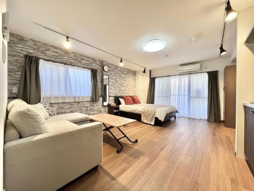 a living room with a couch and a bed at KKHouse in Tokyo