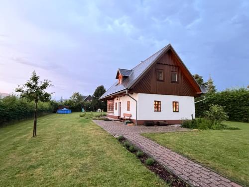a white house with a brown roof at Chalupa Vrchlabi in Vrchlabí