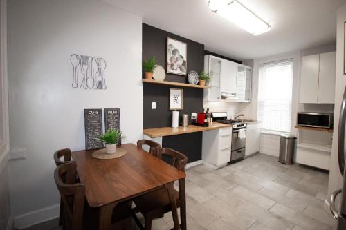 a kitchen with a wooden table and a dining room at Hoboken 15 Min Train to Manhattan Full Kitchen in Hoboken